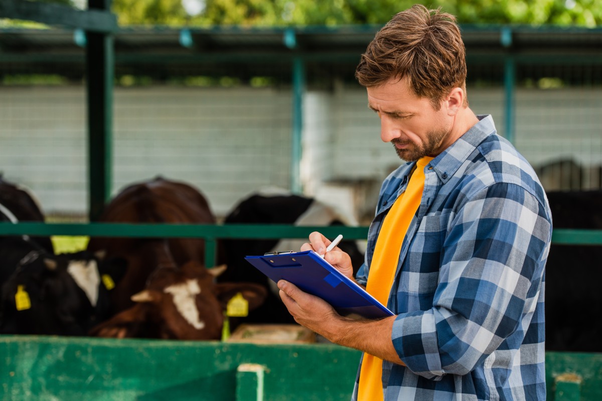 farmer writes on clipboard for reporting 374135452