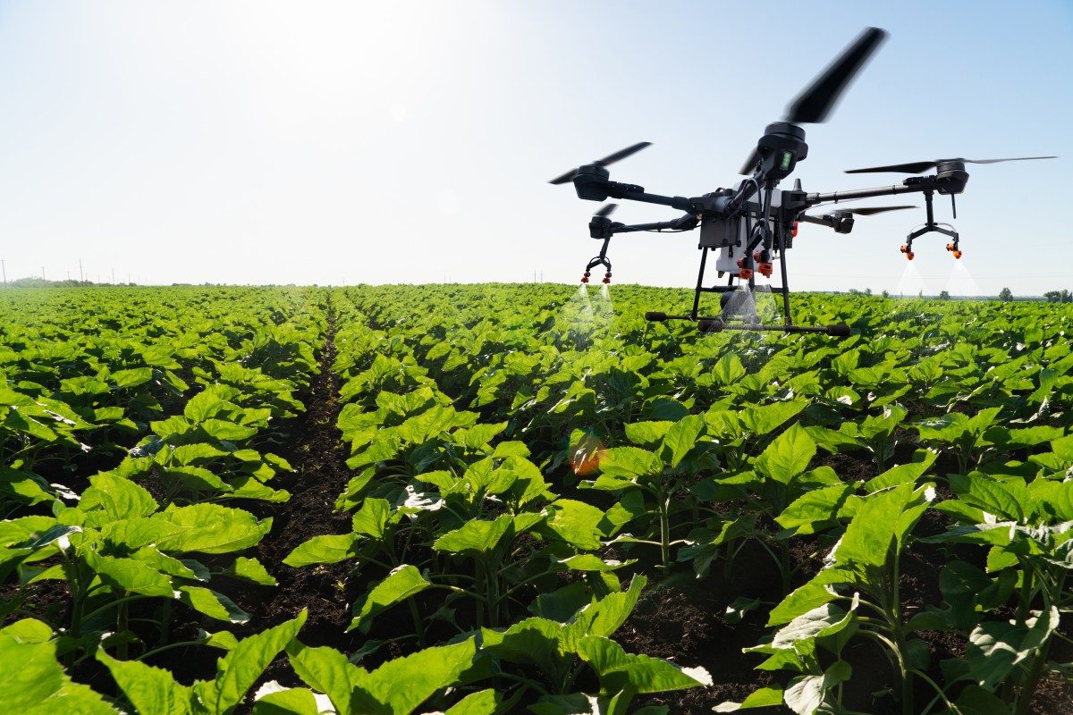 drone flies over field gathering data and spraying 392401438