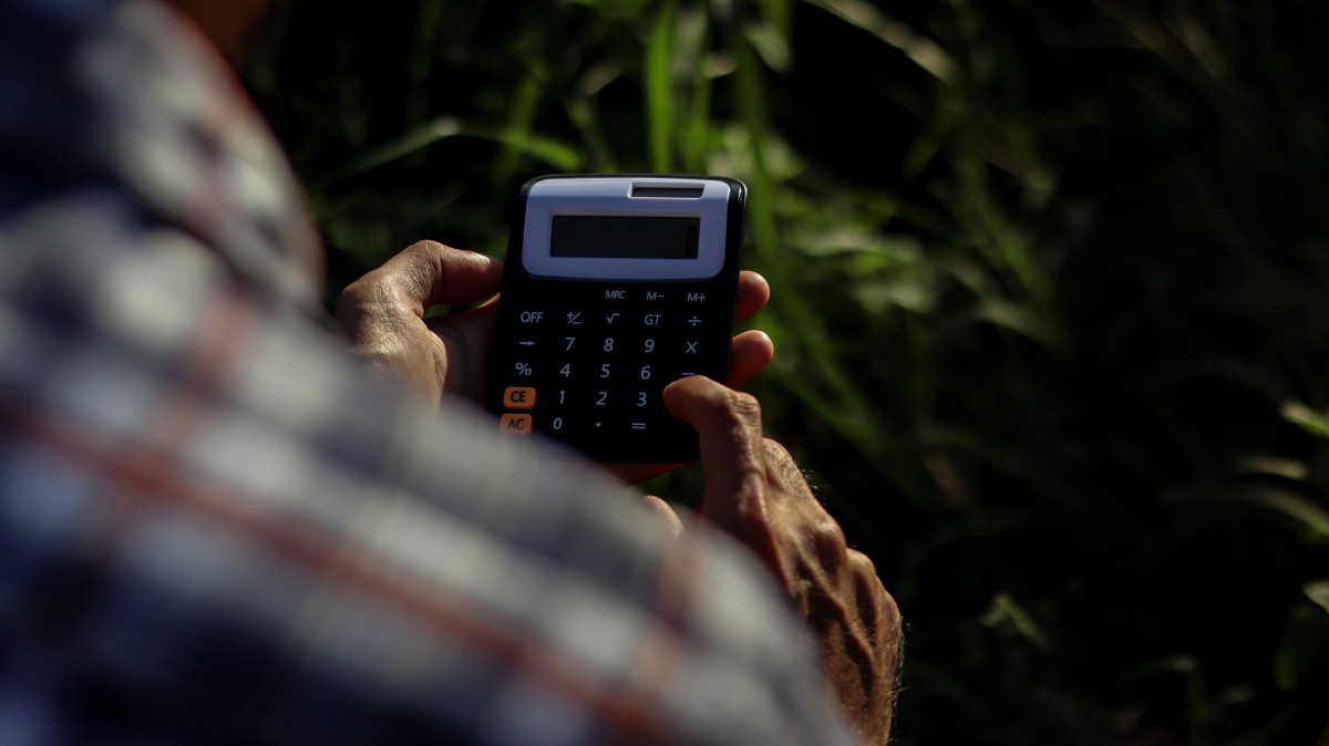 Farmer uses calculator for farm accounting